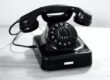 black rotary phone on white table